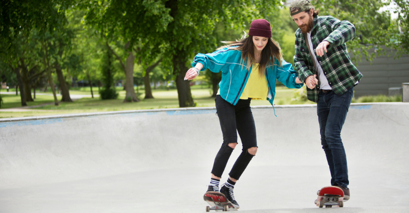 Zwei Menschen üben Skateboardfahren im Park